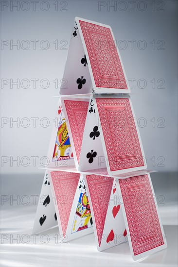 Playing cards stacked into a pyramid.