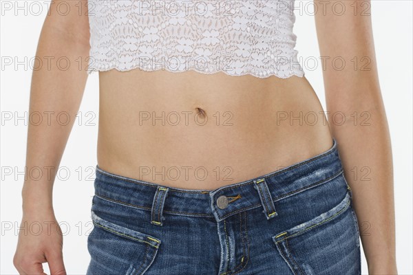 Torso of woman in blue jeans.