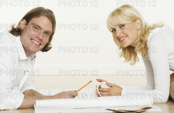 Portrait of couple with blueprints.