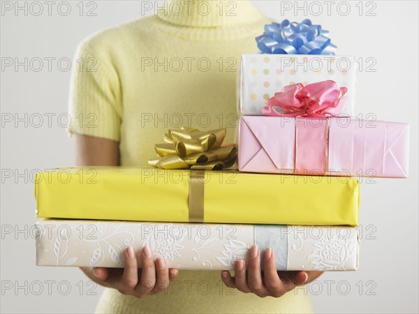 Woman holding pile of presents.
