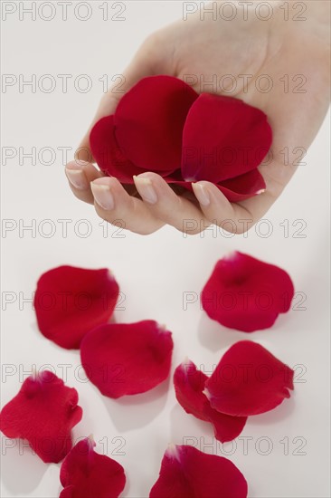 Woman holding rose petals.