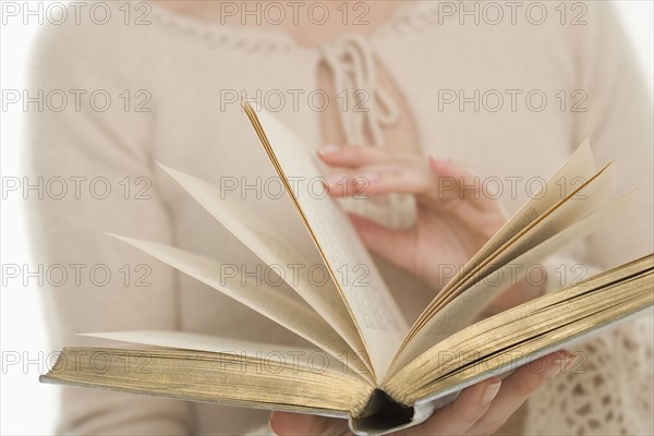 Woman paging through a book.