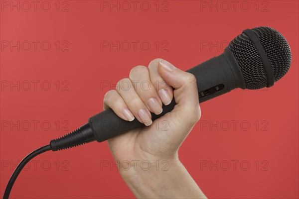 Woman holding microphone.