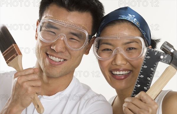 Portrait of couple doing home repairs.