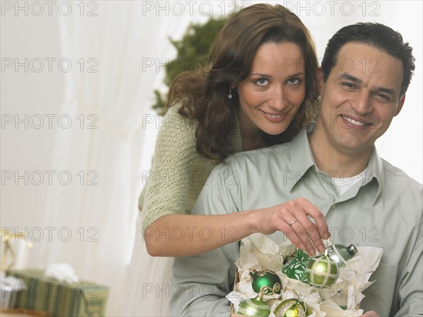 Couple unpacking Christmas ornaments.