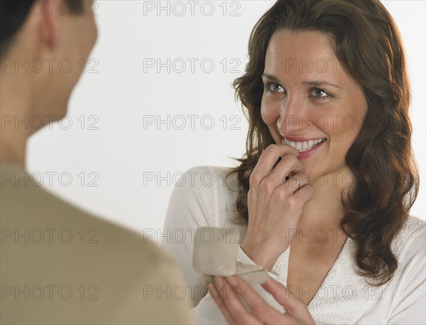 Man giving woman engagement ring.