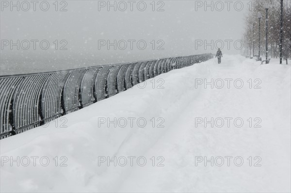 Person walking outdoors in a snowstorm.