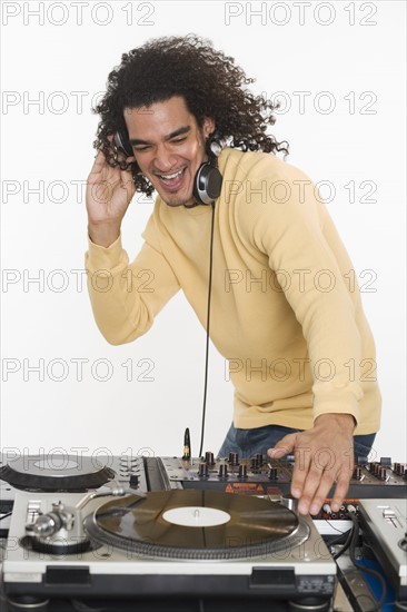 DJ working at music mixing board.