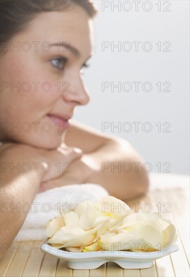 Woman with plate of flower petals.
