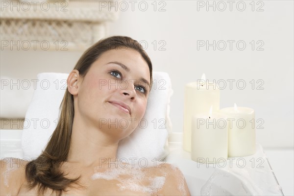 Woman relaxing in bathtub.