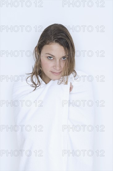 Woman with wet hair wrapped in towel.