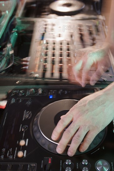 Person mixing music in a nightclub.