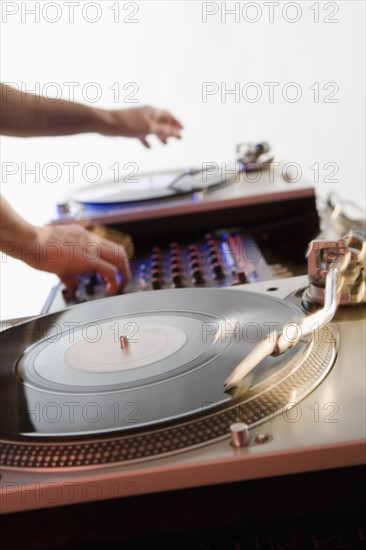 Person mixing sound from records.