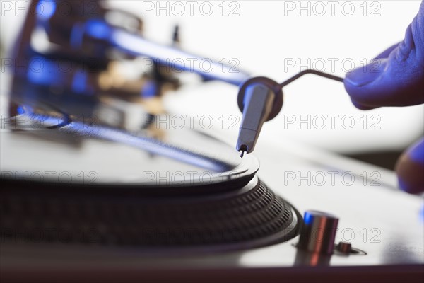 Person setting needle on a record.