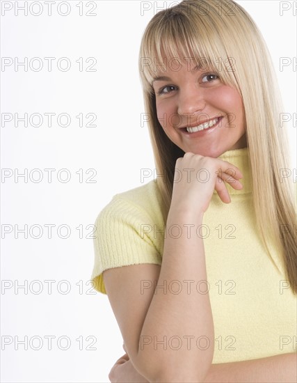 Studio shot of woman smiling.