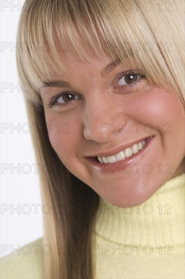 Studio shot of woman smiling.