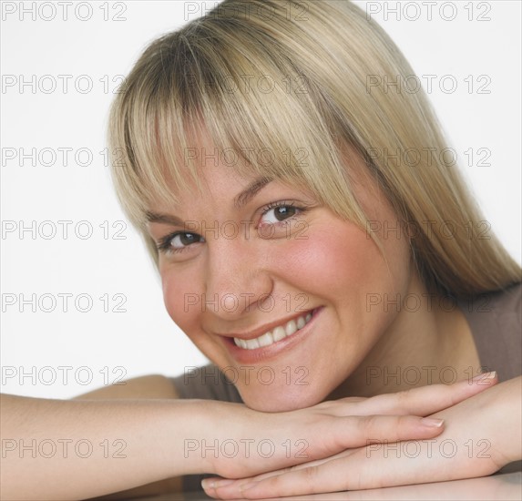 Studio shot of woman smiling.