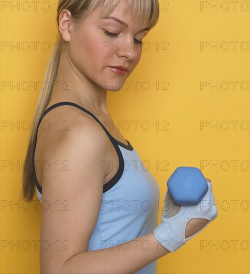 Woman working out with dumbbell.