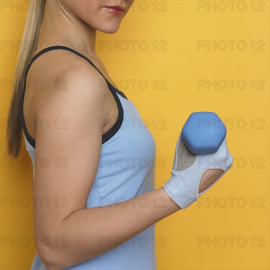 Woman working out with dumbbell.