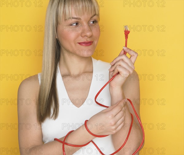 Studio shot of woman with cable.