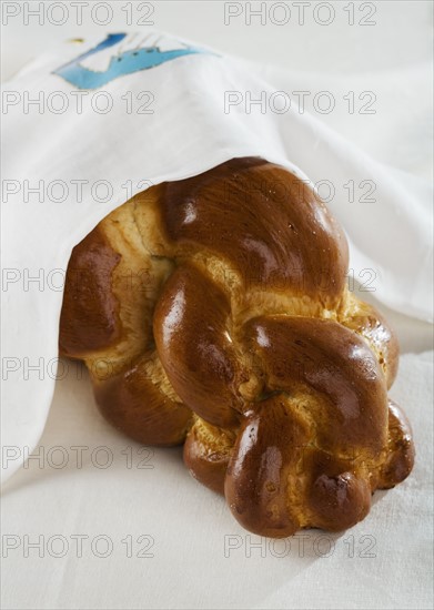 Loaf of Challah bread under cloth.