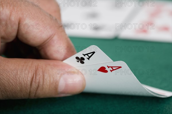 Close up of pair of aces on poker table.