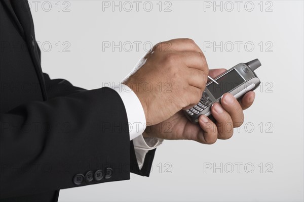 Close up of businessman using PDA.