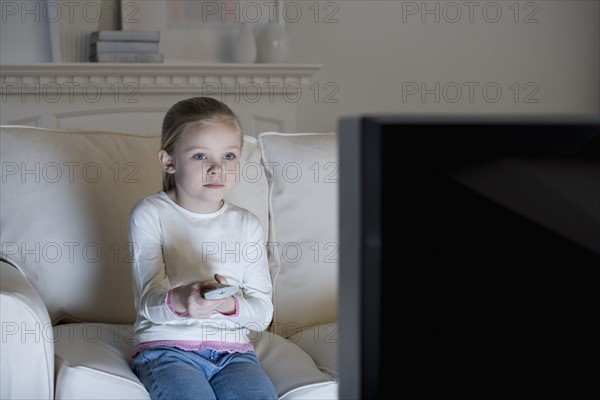 Young girl watching television .