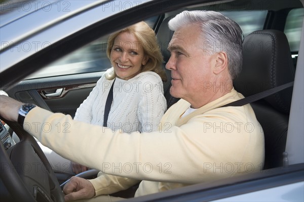 Senior couple driving in car.