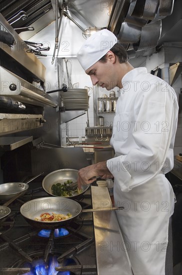 Male chef in restaurant kitchen.