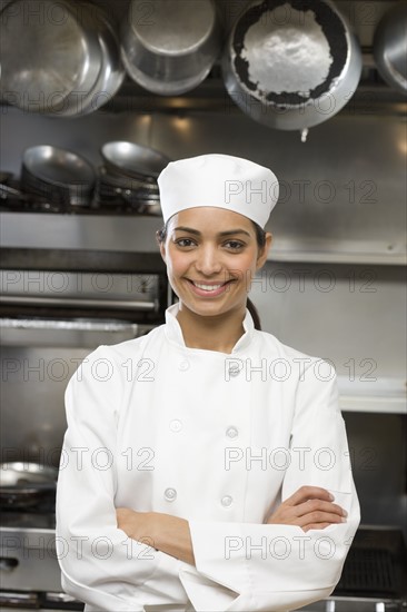 Female chef in restaurant kitchen.