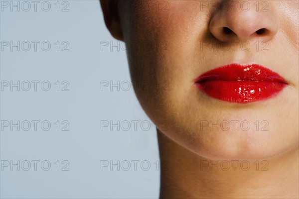 Closeup of female face with red lips.