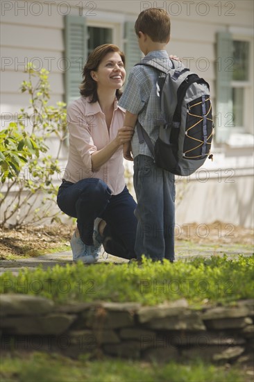 Mother seeing young son off to school.