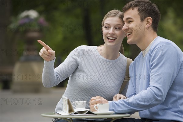 Couple having coffee at outdoor café.