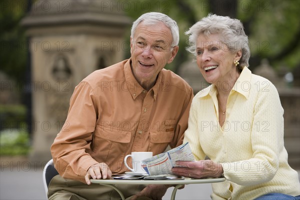 Senior couple having coffee at outdoor café.