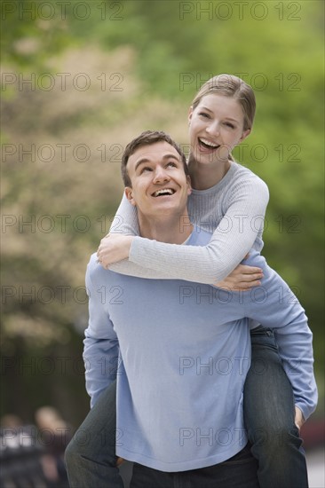 Boyfriend giving girlfriend piggyback ride.