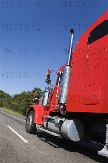 Large red truck on the highway.