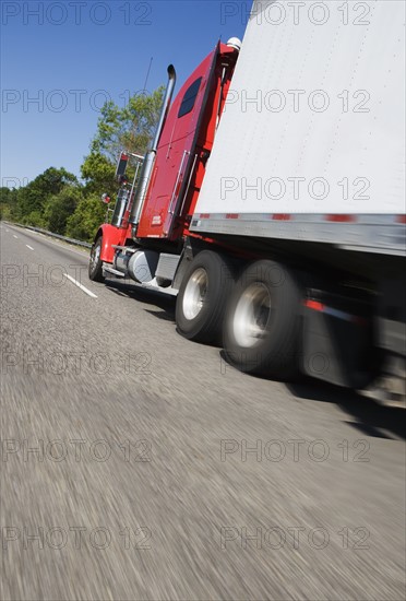 Side angle view of tractor trailer on highway.