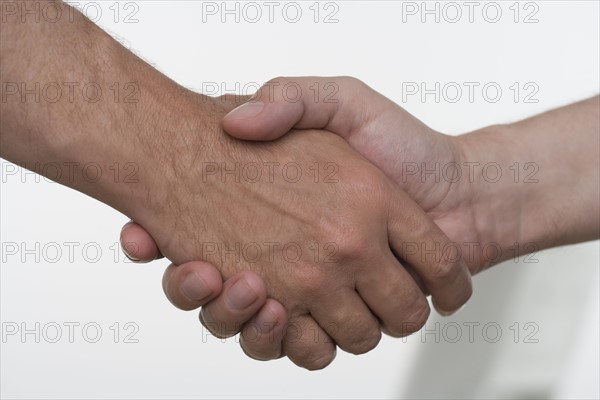 Closeup of men shaking hands.