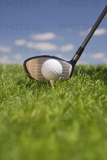 Closeup of golf ball teed up for play.