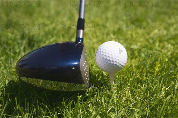 Closeup of golf ball teed up for play.