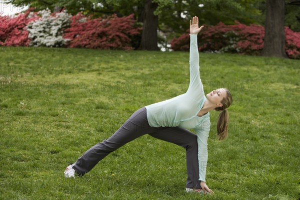 Woman stretching in park.