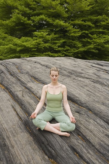 Woman practicing yoga in park.