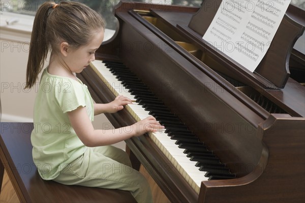 Young girl playing piano.