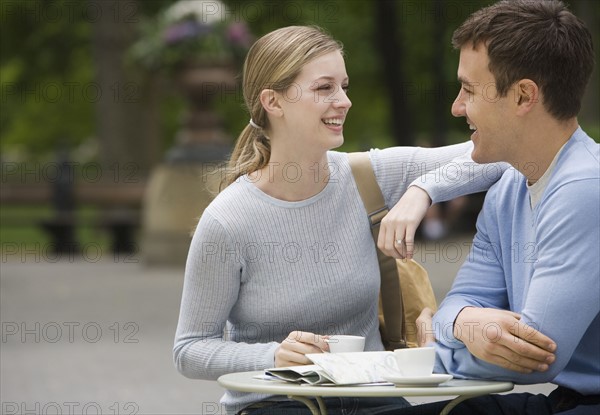 Couple having coffee at outdoor café.