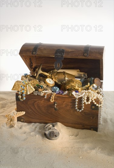 Wooden chest overflowing with treasure.