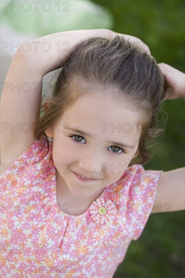 Young girl smiling outdoors.