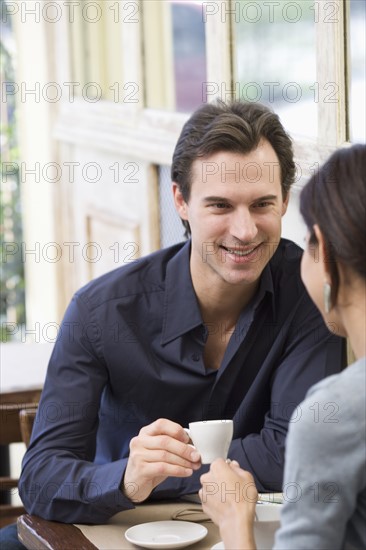 Couple having coffee at restaurant.