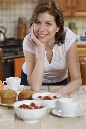 Woman in kitchen with breakfast food.