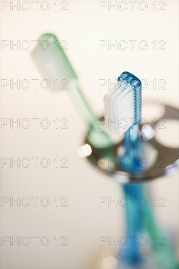 Close up of toothbrushes in holder.